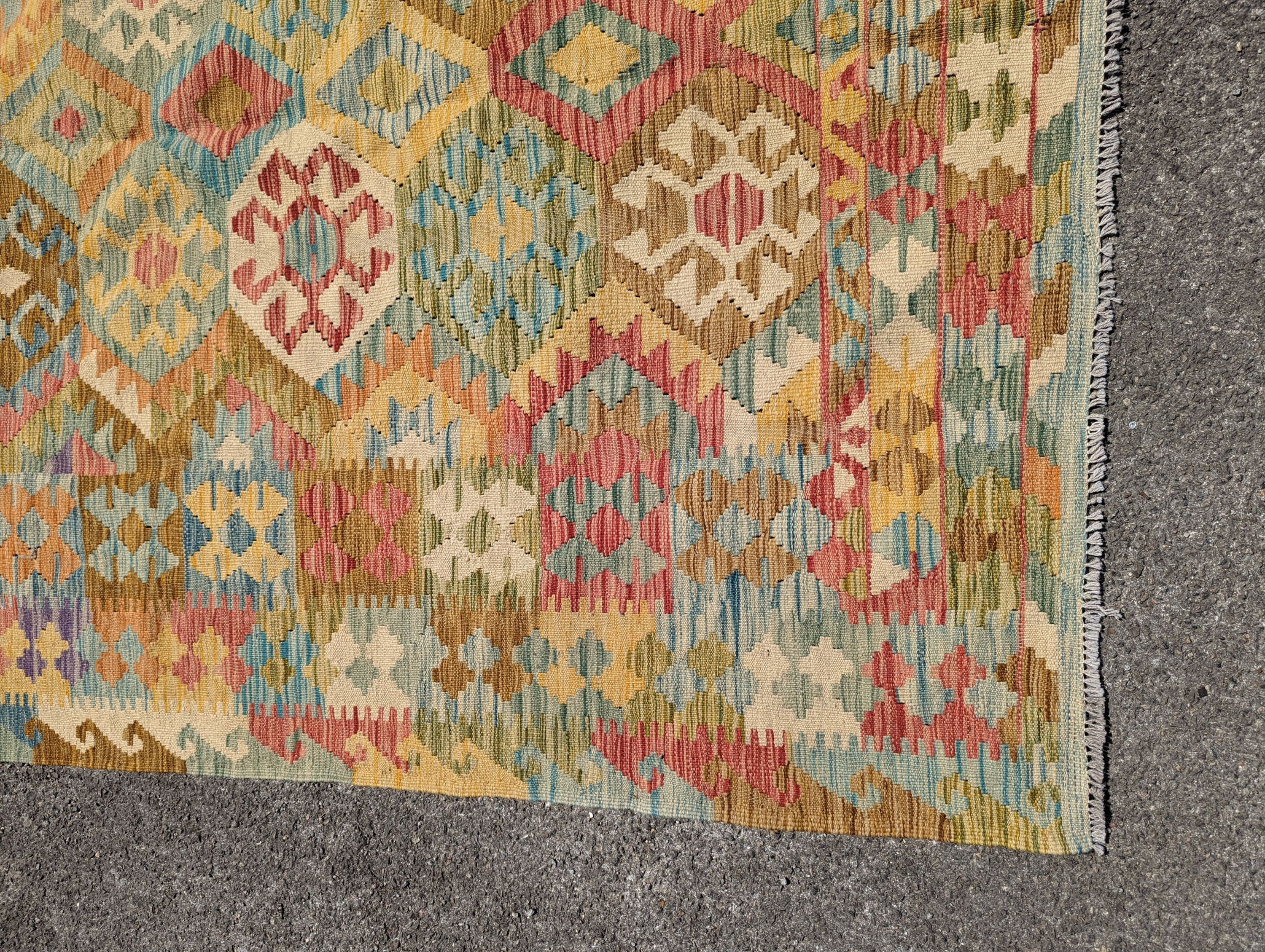 An Anatolian design polychrome geometric flatweave Kilim carpet 270 x 200cm